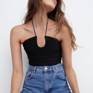 Detail of black halter top with ruching texture and deep U-neckline style