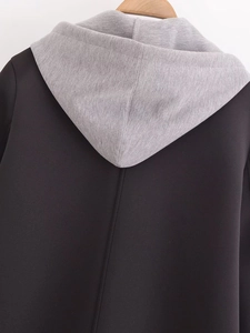 Detail view of contrast hood stitching and soft cotton blend fabric on a black hoodie