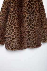 Detailed view of leopard print faux fur texture on a warm winter coat for women