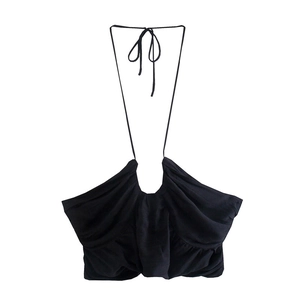 Detail shot of black halter neck top featuring elegant ruching and adjustable ties