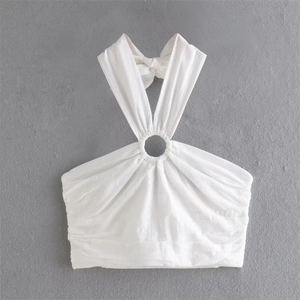 Detailed flat lay of white halter neck top with metal ring buckle and tie-back knot