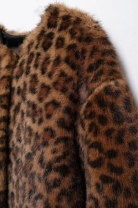 Detail shot of leopard print faux fur texture with high-density plush and smooth black lining