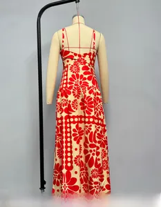 Detail view of red floral maxi dress showing the crossover spaghetti strap back design