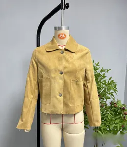 Detail view of ginger suede short jacket featuring classic lapels and large patch pockets