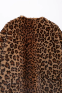 Detailed macro shot of the leopard print faux fur texture on the collar and back