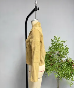 Detail of camel faux suede jacket featuring long sleeves, lapel collar, and large side pockets
