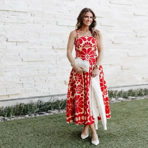 Detail view of summer midi dress with bold red and beige floral prints and slim waistline