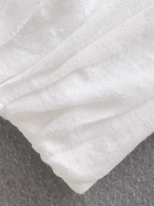 Close-up of white breathable linen cotton fabric texture for women's summer top