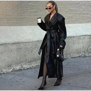 Chic black faux leather long trench coat with waist belt and lapel collar for women