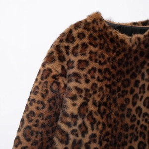 Close-up of leopard print faux fur coat featuring dense animal texture and soft lining