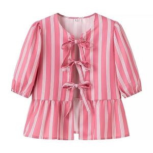 Close-up of pink and white striped shirt with three pink bow ties and peplum hem details