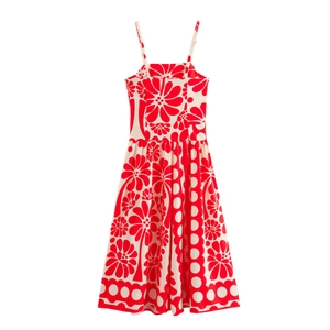 Detail of red floral print and polka dot pattern on a summer A-line maxi dress