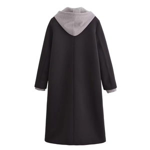 Back view of a long black hooded coat with grey patchwork sleeves and a detachable hood