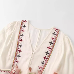 White V-neck summer mini dress with colorful ethnic embroidery and button details