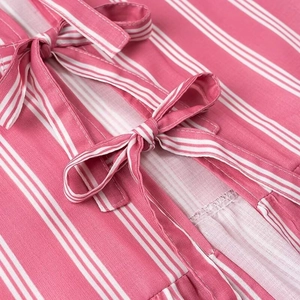 Detail of pink and white vertical stripes on shirt fabric with bow tie-up knot feature