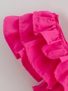 Close-up of rose pink multi-layered ruffle design and smooth stitching on summer jumpsuit