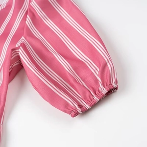 Detailed close-up of pink and white striped lantern sleeves with elastic ruffled cuffs