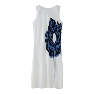 Close-up of pleated white sleeveless dress with large blue abstract floral print details