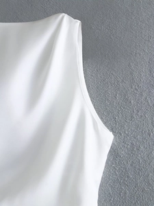 Close-up of white backless satin top showing clean neckline stitching and premium fabric