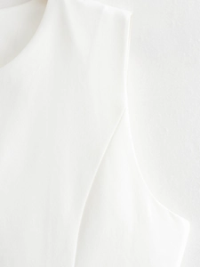 Macro detail of high-quality white sleeveless suit vest fabric and seamless stitching