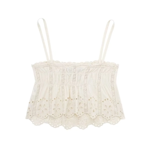 Close-up of white broderie anglaise crop top with pleated chest and wavy lace hem