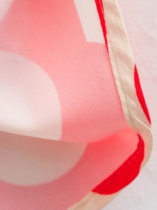 Close-up of pink and white polka dot print fabric with high-quality stitching details