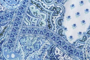 Close-up of blue paisley and floral print pattern on high-quality woven fabric