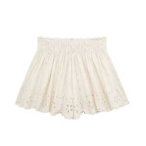 Detailed view of women's white cotton shorts with eyelet embroidery and elastic waistband