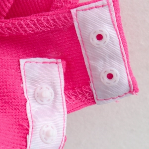 Summer sleeveless ribbed knit romper in magenta featuring ruffle trim and snap closures