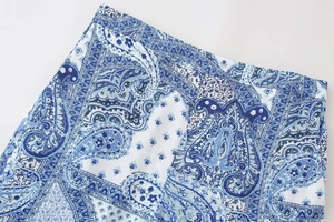 Detail of blue and white paisley print on breathable cotton linen fabric for women