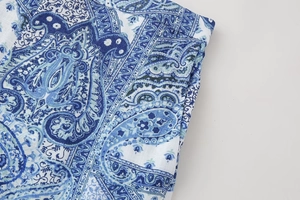 Close-up of blue paisley print on cotton linen fabric with clean stitching details
