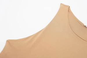 Macro detail of beige halter jumpsuit neckline showing premium stitching and size S label