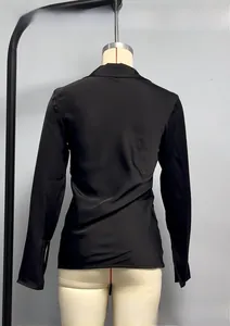 Detail of elegant black satin shirt showing smooth silk texture and premium back stitching
