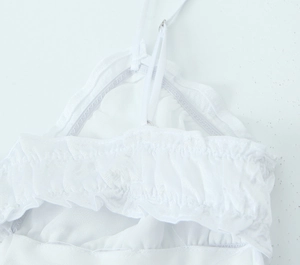 Close-up of white layered satin midi dress with ruffled edges and adjustable straps