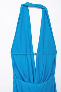 Detail of bright blue halter neckline with deep V-neck and decorative metal buckle