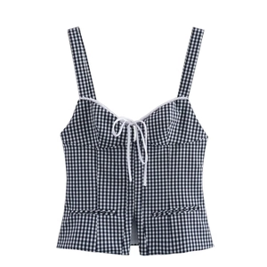 Detail of gingham crop top featuring sweetheart neckline with adjustable front tie detail