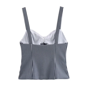 Detailed close-up of a black and white gingham corset top with delicate ruffle trim and straps