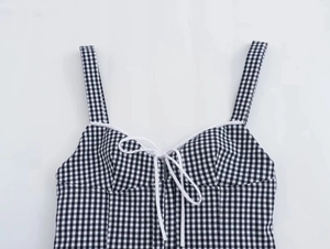 Detail of black and white gingham corset top with delicate drawstring tie at the neckline