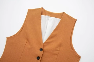 Detail of V-neck linen waistcoat showing ginger fabric texture and black buttons