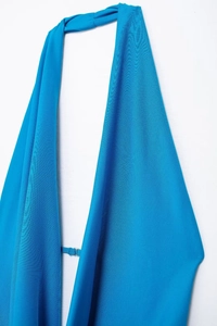 Detail of lake blue halter neck dress with adjustable metal buckle on thin back strap