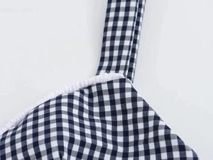 Detailed view of black and white gingham corset top with white elastic ruffle neckline
