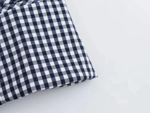 Close-up of black and white gingham fabric texture for summer corset top