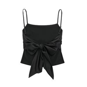 Women's black satin camisole top featuring a large back bow tie and glossy silk texture
