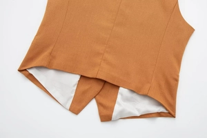 Detail of V-shaped back hem with smooth white lining on brown linen blend vest