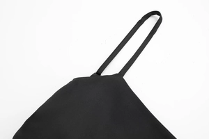 Close-up of black satin top shoulder strap with fine stitching on minimalist background