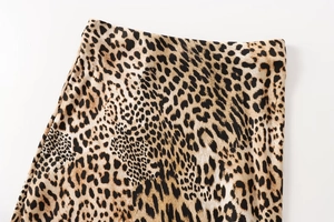Detailed close-up of leopard print skirt waist showing silky texture and fine stitching