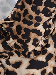 Detail of leopard print shirt showing ruffled edges and woven texture on fabric