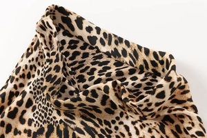 Close-up of silky leopard print fabric detail with classic brown and black animal pattern