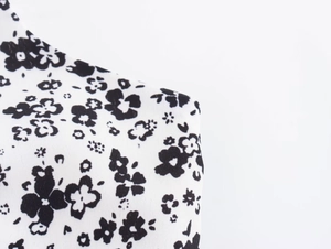 Close-up of black and white floral print fabric with high-quality textile texture details