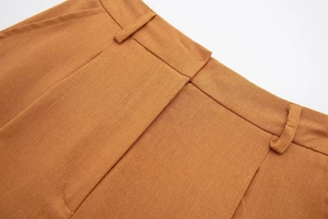 Detailed view of linen blend casual pants with waist loops and side pockets in tan